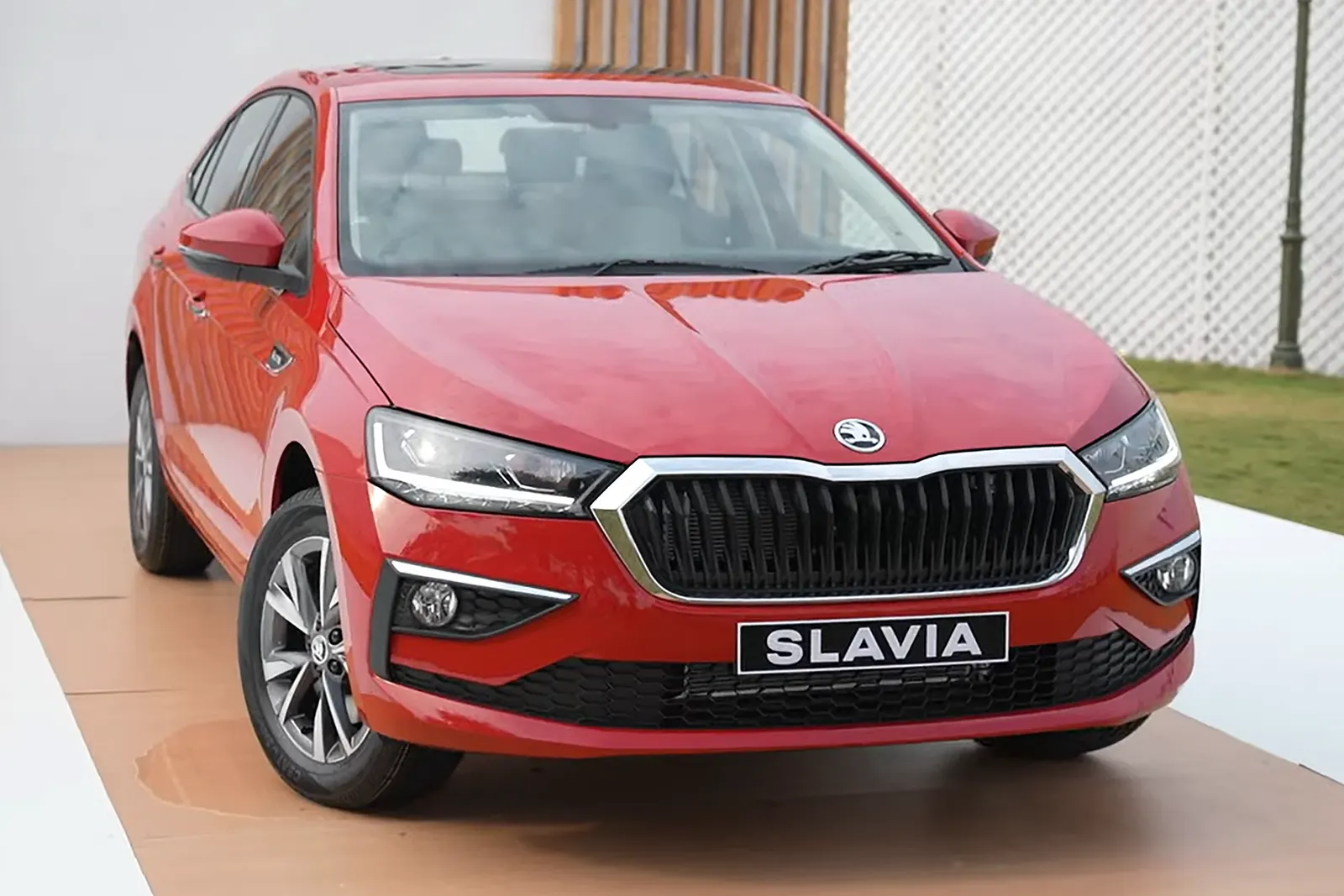 Red Skoda Slavia sedan, front view, India
